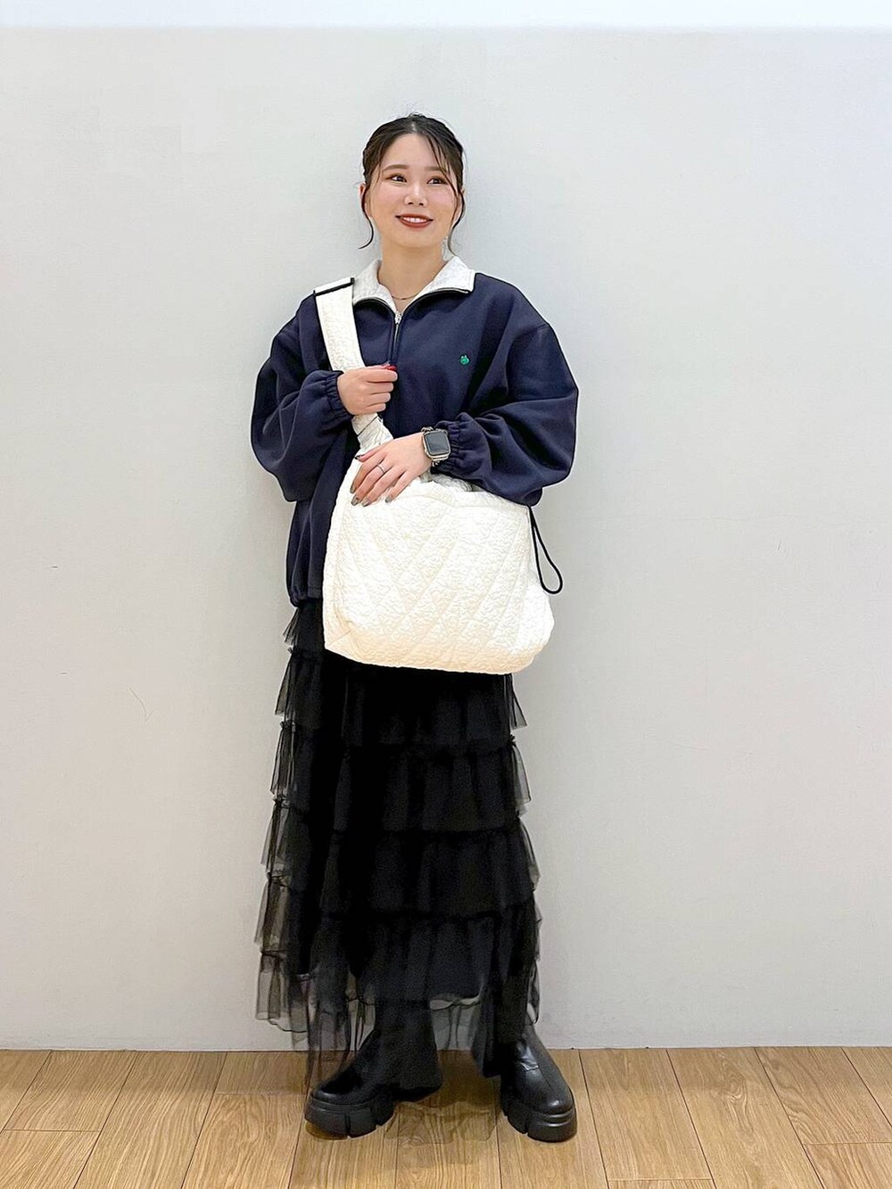 ブラック系のブーツ、ブルー系のスウェット、ブラック系のスカートを着用したレディースの秋コーディネートの4枚目の写真