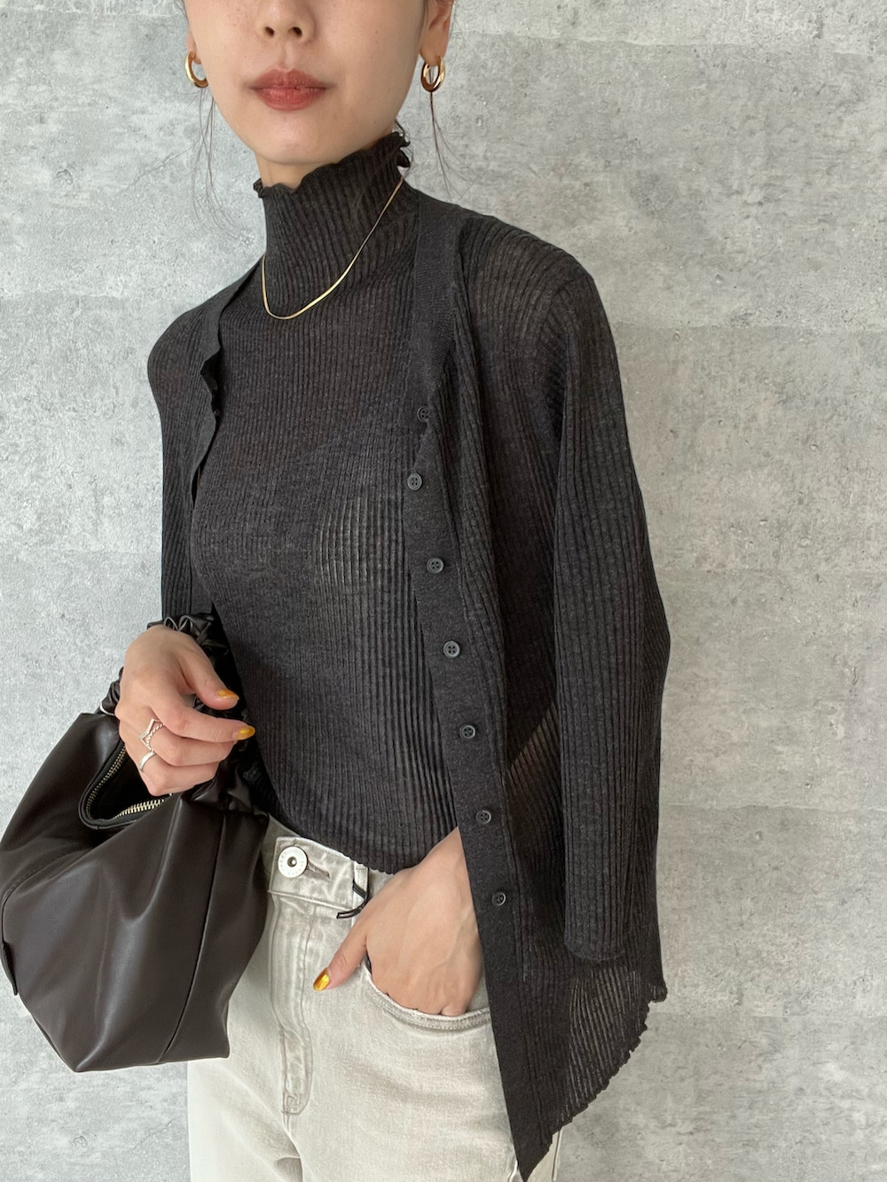 グレー系のカーディガン/ボレロ、グレー系のニット/セーター、グレー系のデニムパンツを着用したレディースの夏コーディネートの2枚目の写真