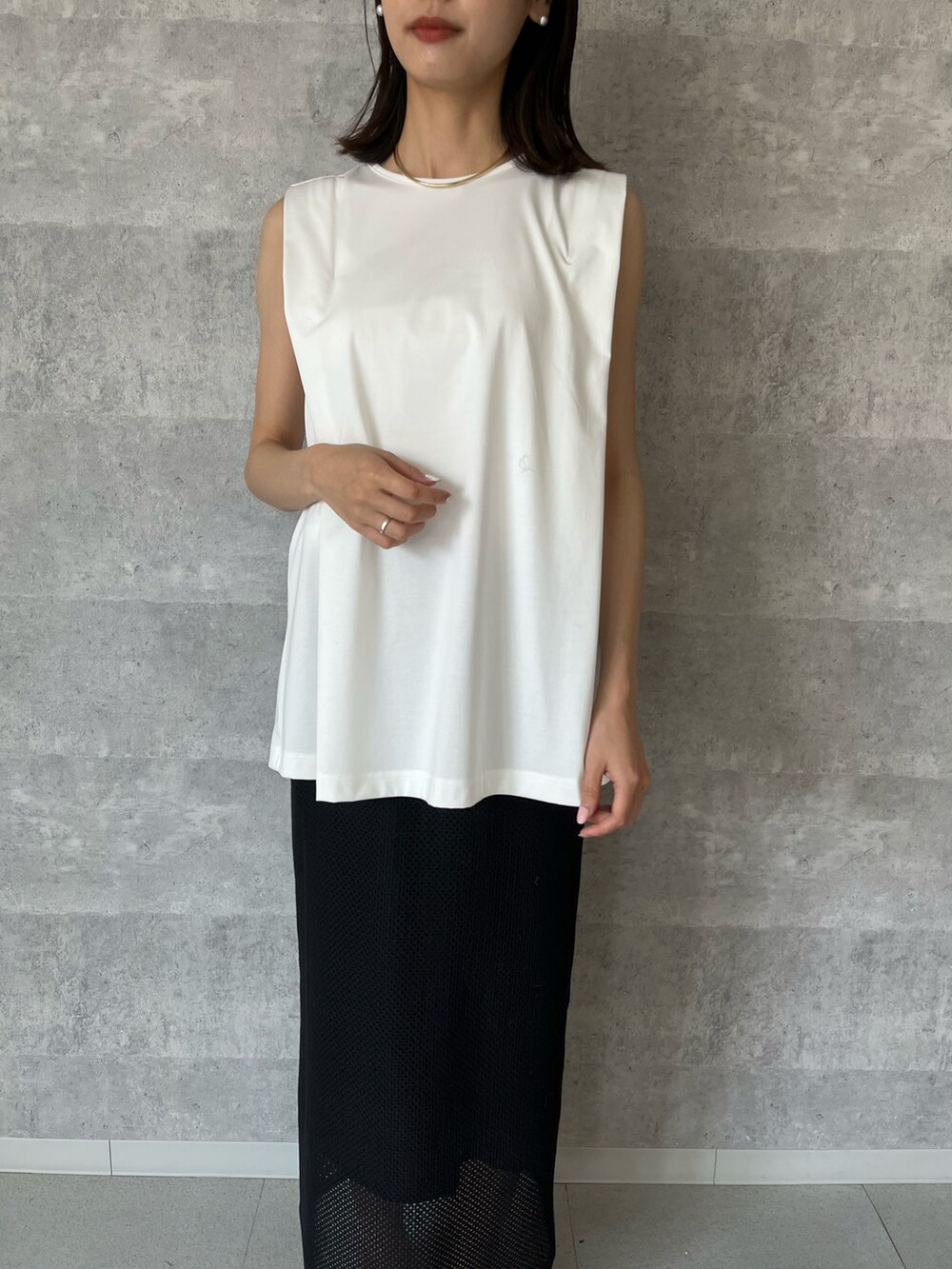 ホワイト系のTシャツ/カットソー、ブラウン系のバッグ、ブラック系のスカートを着用したレディースの春コーディネートの3枚目の写真