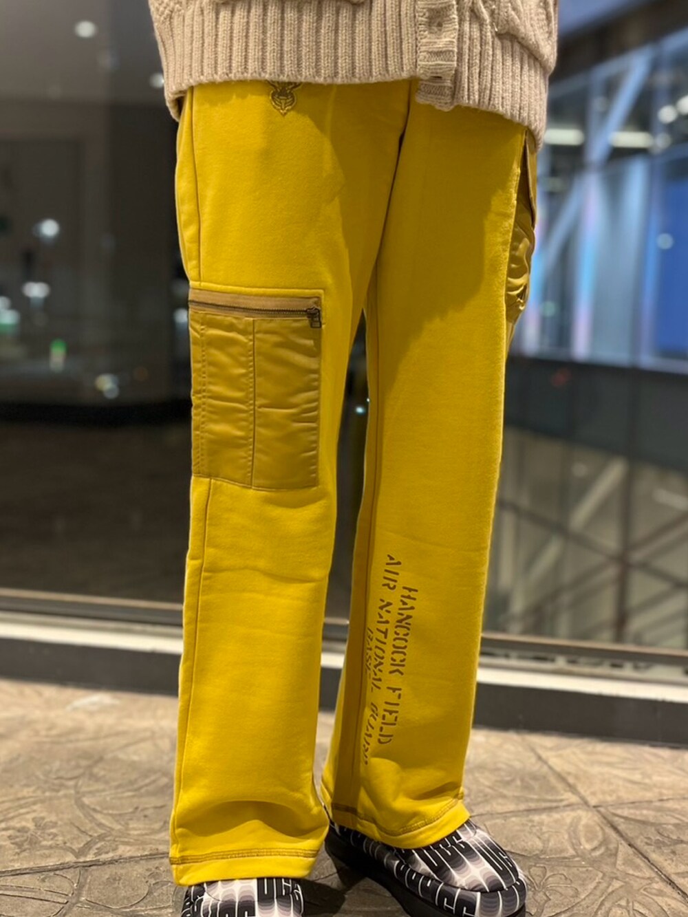 ホワイト系のカーディガン/ボレロ、イエロー系のスウェットパンツを着用したレディースの冬コーディネートの4枚目の写真