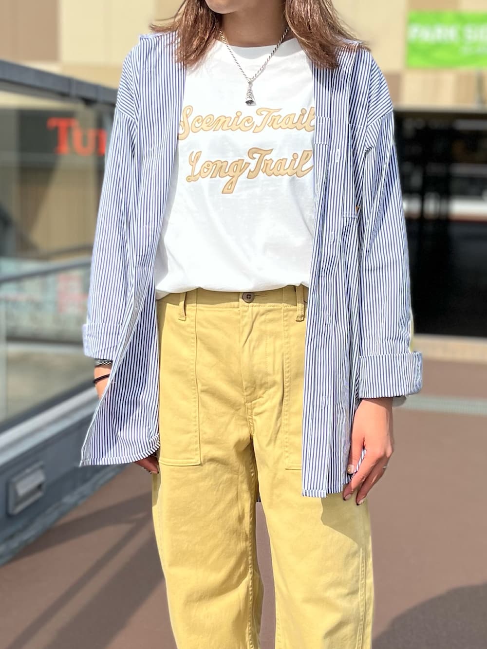 ブラック系のシャツ/ブラウス、ホワイト系のTシャツ/カットソー、ベージュ系のその他パンツを着用したレディースの秋コーディネートの2枚目の写真