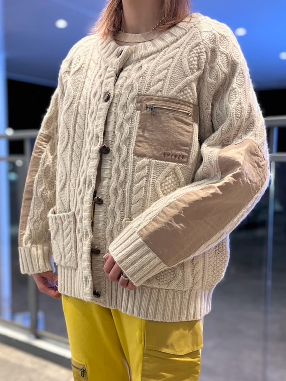 ホワイト系のカーディガン/ボレロ、イエロー系のスウェットパンツを着用したレディースの冬コーディネートの3枚目の写真