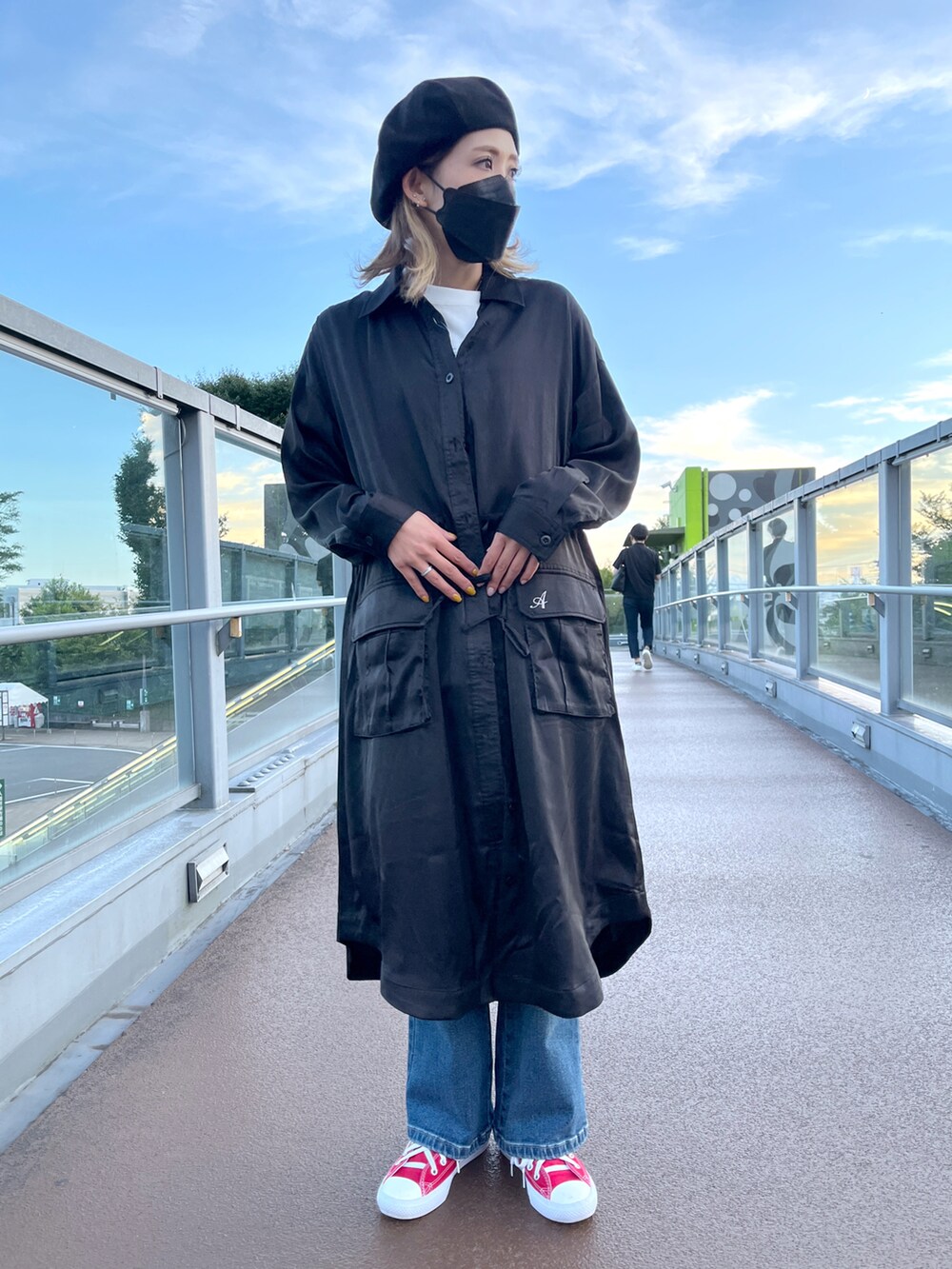 ブルー系のデニムパンツ、ホワイト系のTシャツ/カットソー、ブラック系のシャツワンピースを着用したレディースの秋コーディネートの2枚目の写真