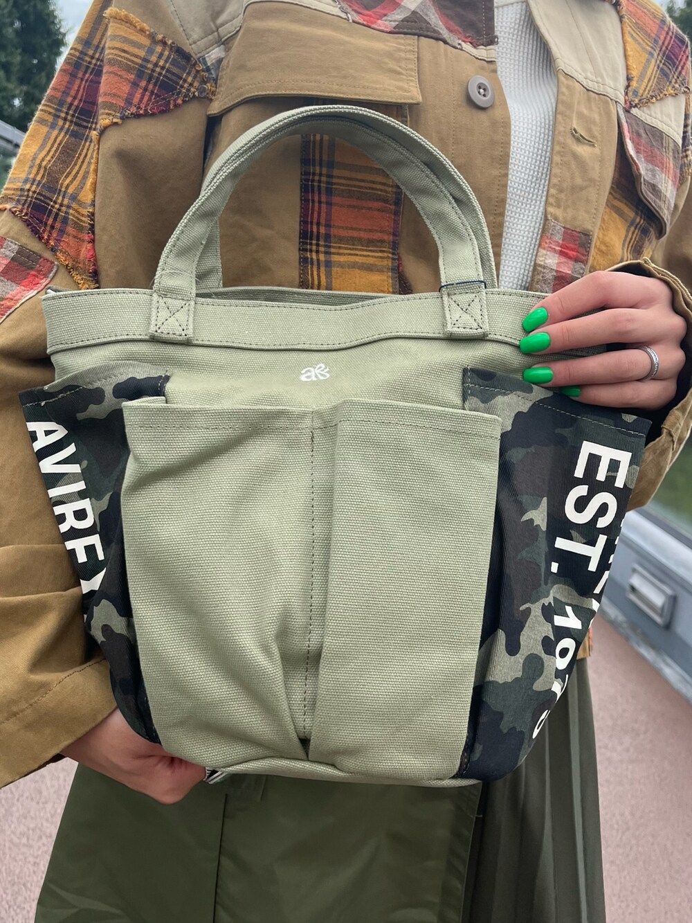 ベージュ系のその他アウター、グリーン系のスカート、ホワイト系のTシャツ/カットソーを着用したレディースの秋コーディネートの4枚目の写真