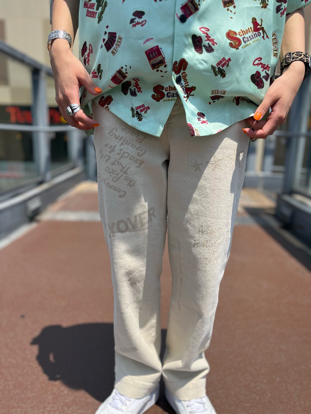 グリーン系のシャツ/ブラウス、ホワイト系のタンクトップ、ホワイト系のチノパンツを着用したレディースの夏コーディネートの3枚目の写真