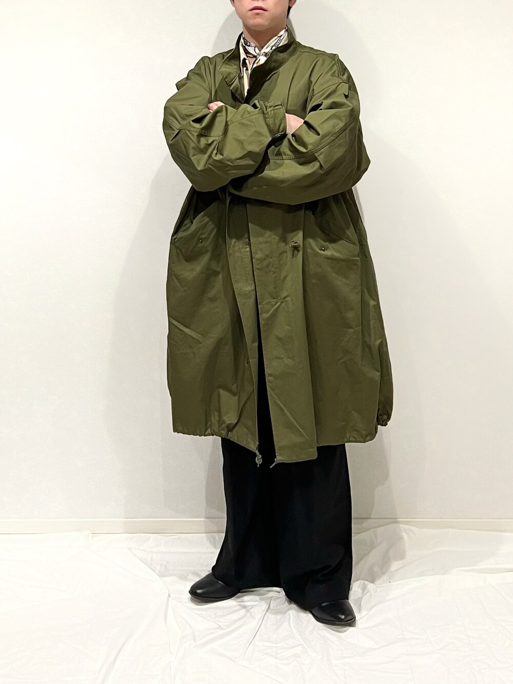 グリーン系のミリタリージャケット、ブラウン系のショルダーバッグ、ブラック系のスラックスを着用したメンズの秋コーディネートの3枚目の写真