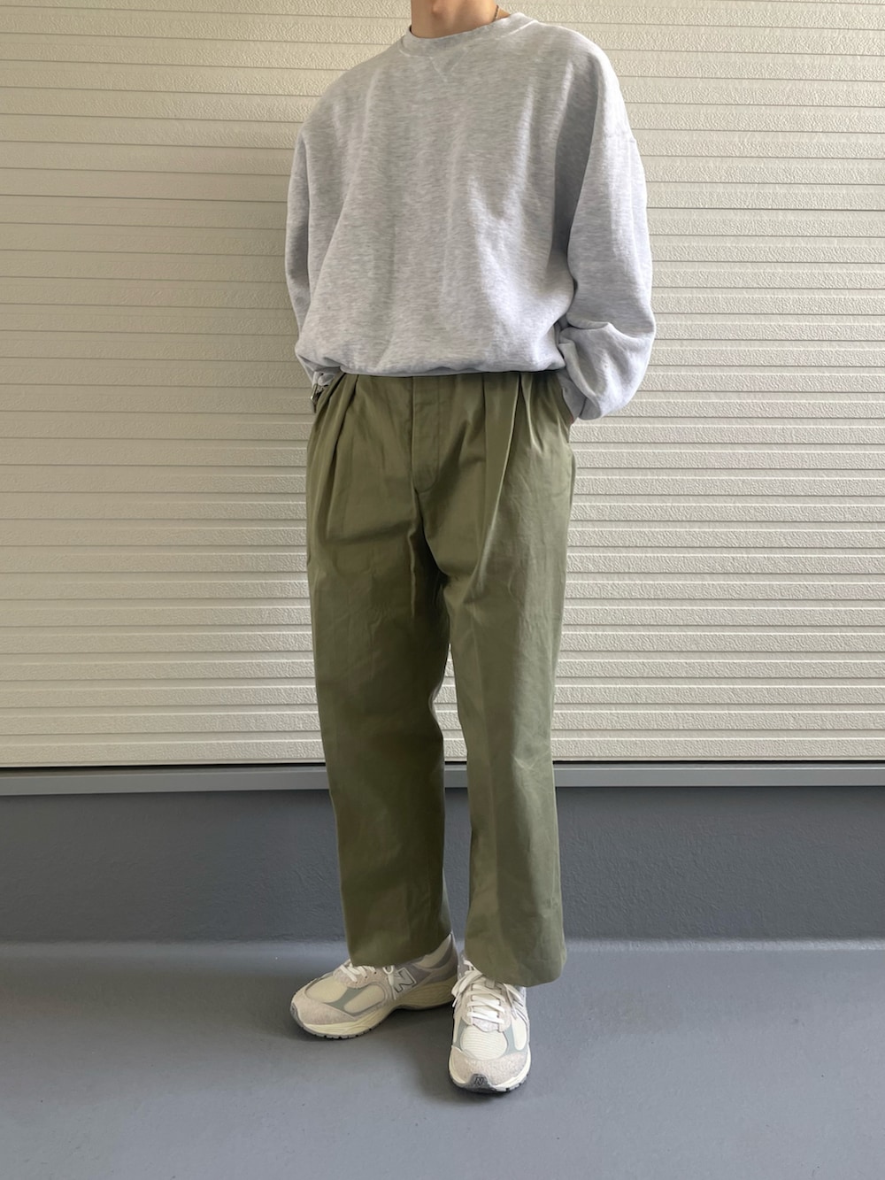 ホワイト系のスニーカー、グリーン系のパンツ、グレー系のスウェットを着用したメンズの春コーディネートの3枚目の写真