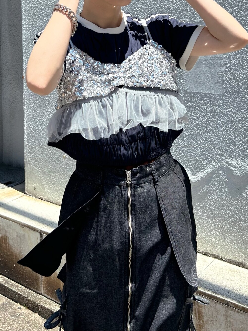 ブラック系のデニムスカート、ブルー系のTシャツ/カットソー、グレー系のキャミソールを着用したレディースの夏コーディネートの2枚目の写真