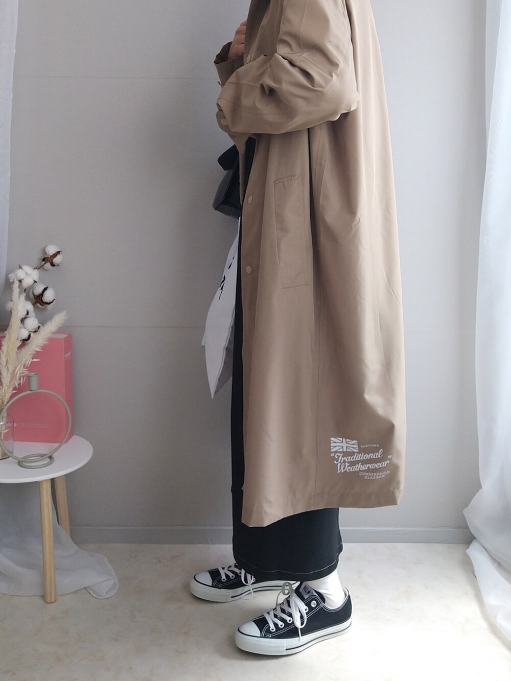 ブラック系のワンピース、ブラック系のショルダーバッグ、ホワイト系のトートバッグを着用したレディースの春コーディネートの3枚目の写真