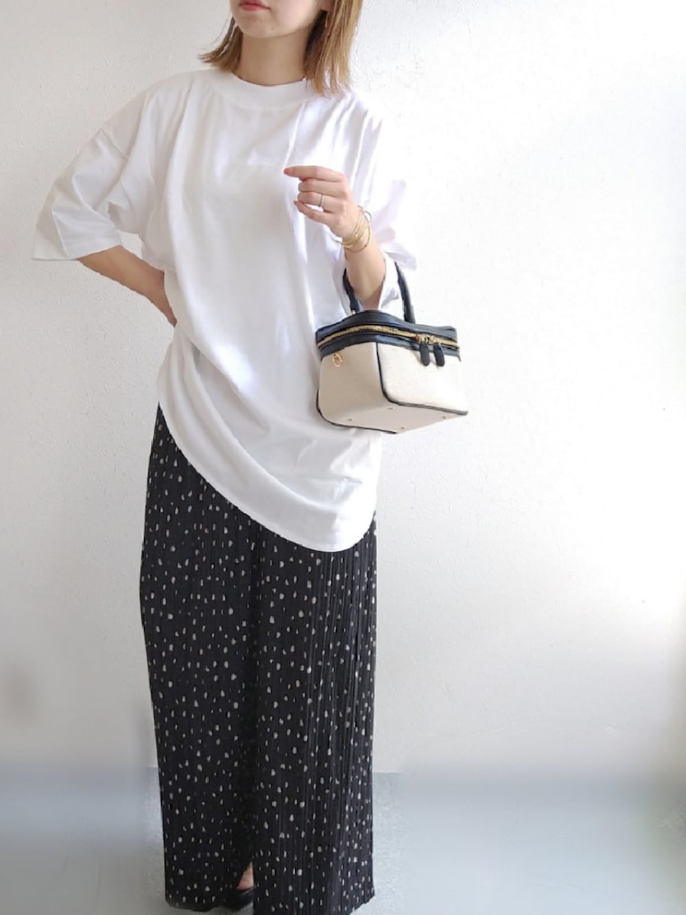 ホワイト系のTシャツ/カットソー、ブラック系のその他パンツ、ブラック系のサンダルを着用したレディースの春コーディネートの3枚目の写真