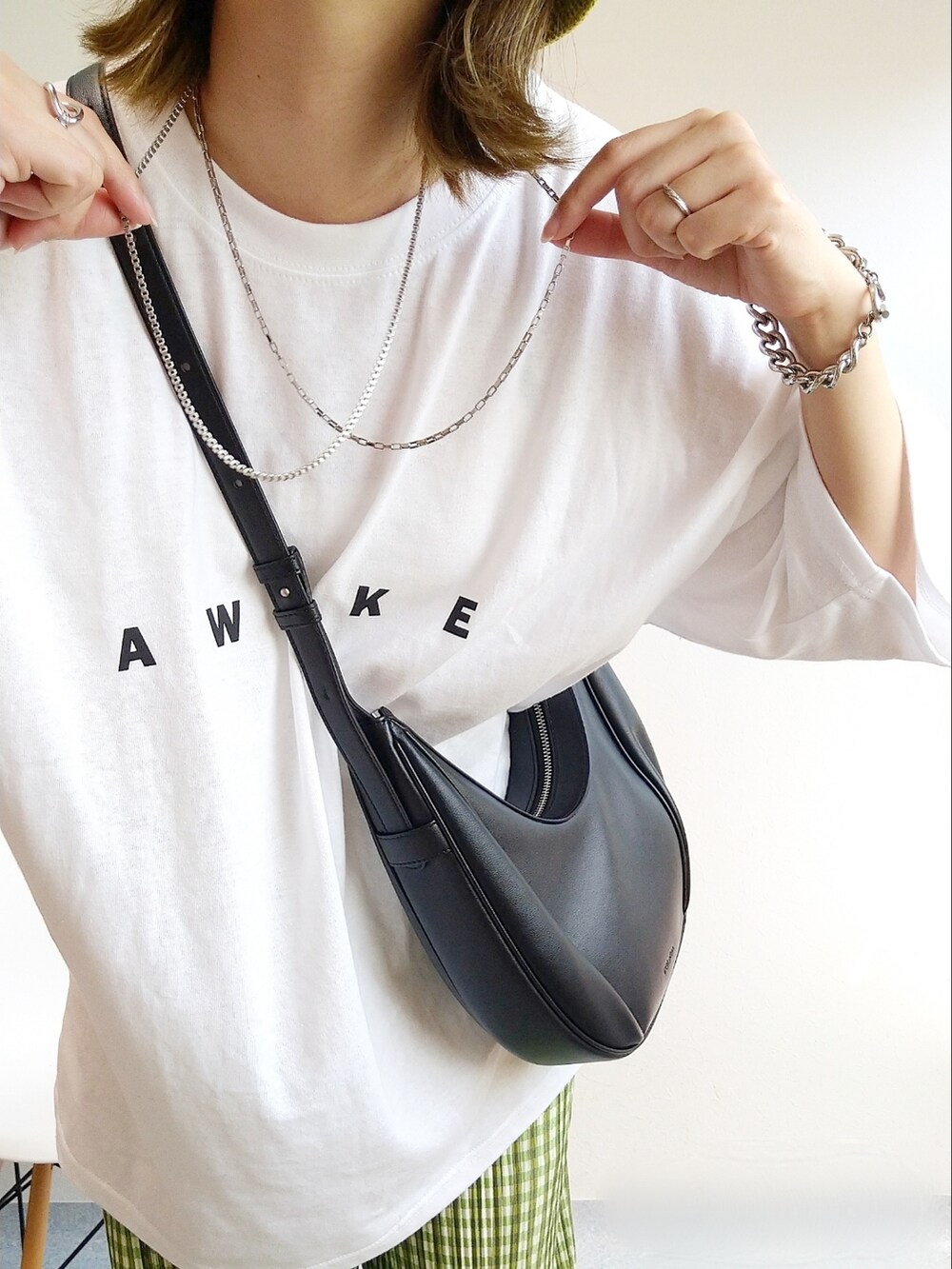ホワイト系のTシャツ/カットソー、グリーン系のその他パンツ、ブラック系のサンダルを着用したレディースの春コーディネートの3枚目の写真