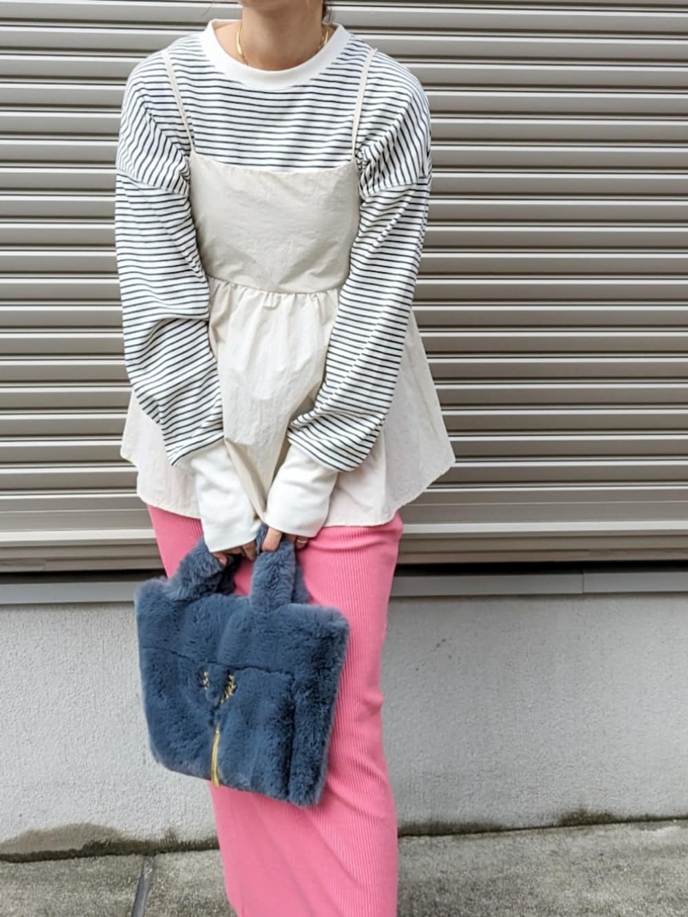 ベージュ系のTシャツ/カットソー、グレー系のハンドバッグ、ピンク系のスカートを着用したレディースの秋コーディネートの2枚目の写真