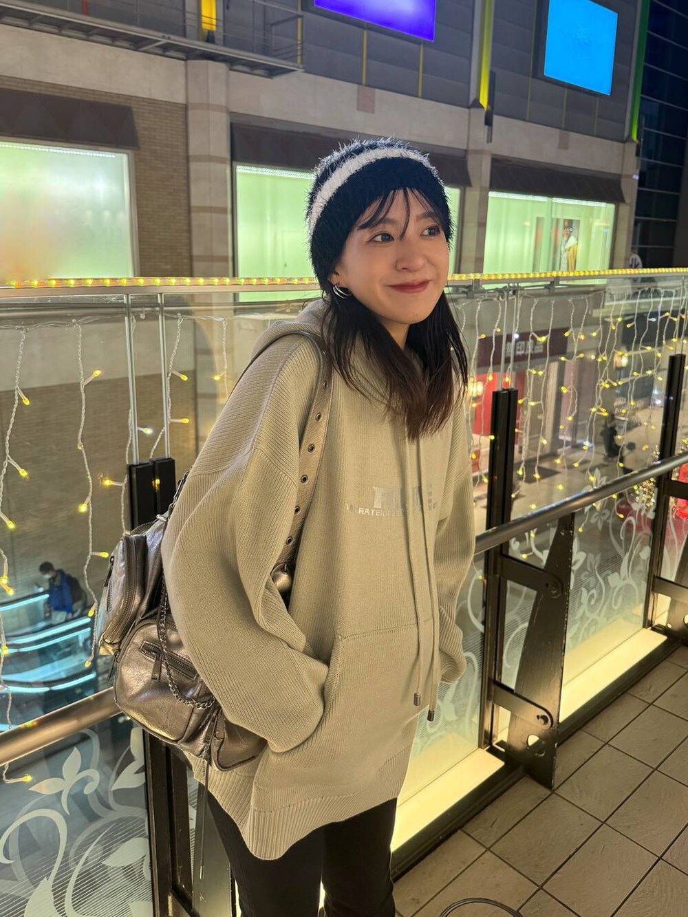 シルバー系のショルダーバッグ、ベージュ系のニット/セーターを着用したレディースの秋コーディネートの4枚目の写真