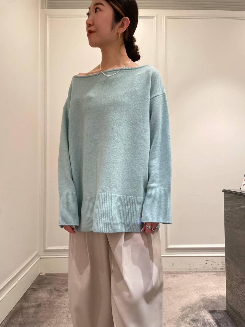グリーン系のニット/セーター、ベージュ系のその他パンツ、ブラック系のショルダーバッグを着用したレディースの冬コーディネートの7枚目の写真