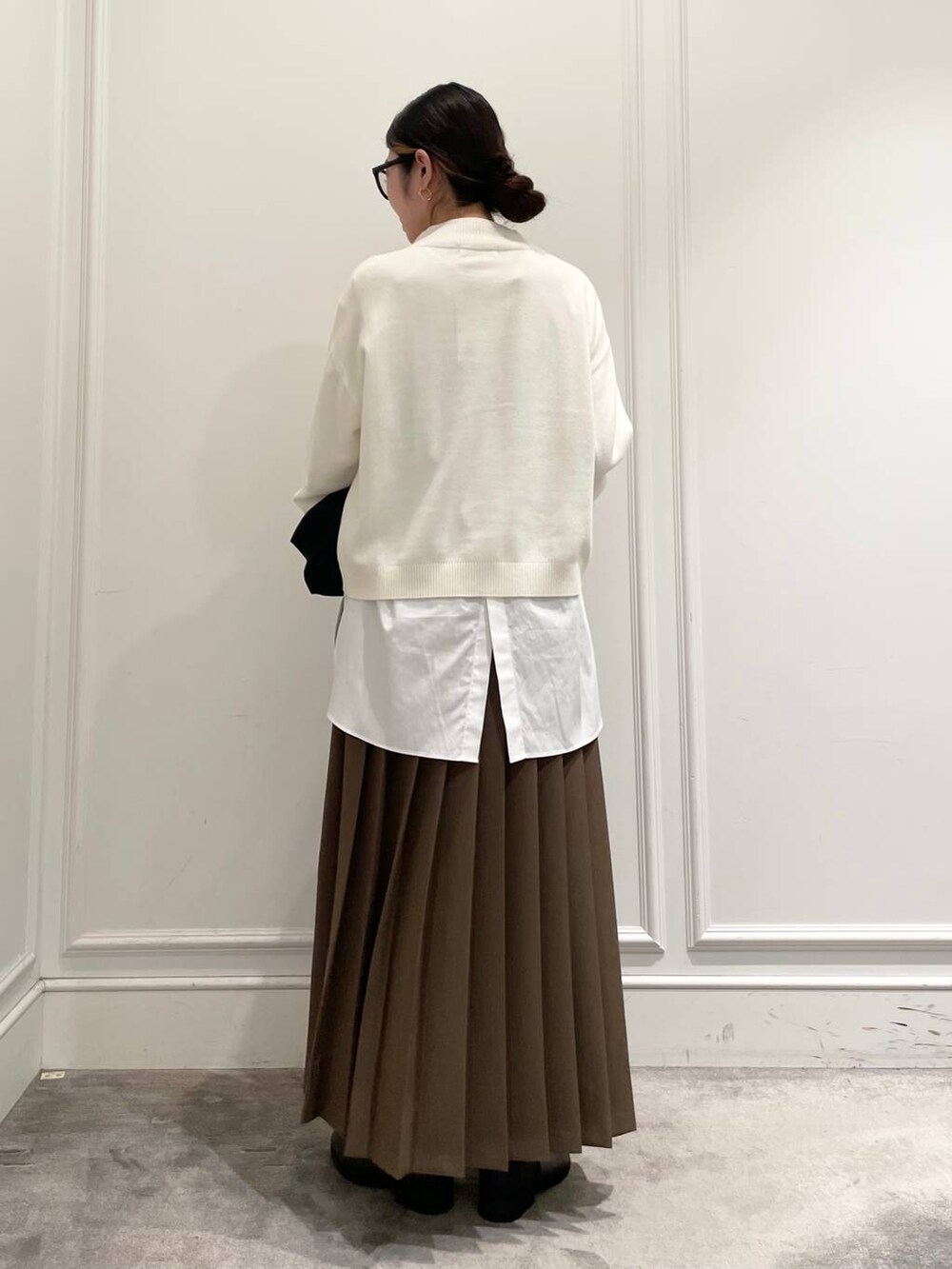 ブラック系のショルダーバッグ、ブラウン系のスカート、ホワイト系のシャツ/ブラウスを着用したレディースの冬コーディネートの5枚目の写真