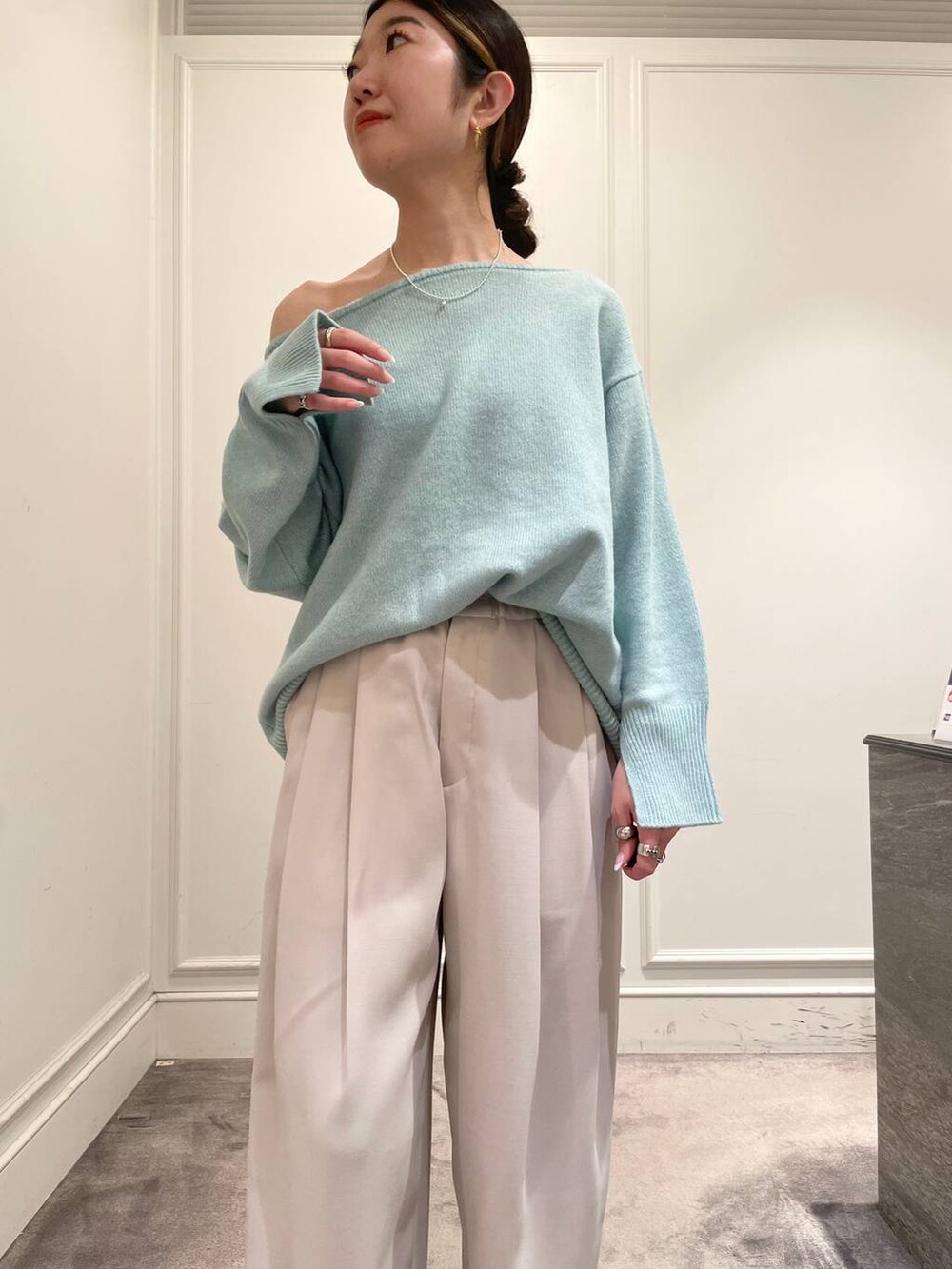 グリーン系のニット/セーター、ベージュ系のその他パンツ、ブラック系のショルダーバッグを着用したレディースの冬コーディネートの6枚目の写真