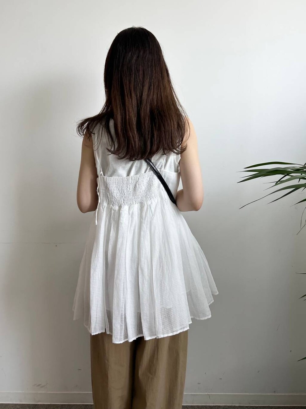 ホワイト系のタンクトップ、ホワイト系のキャミソール、ブラック系のキャミソールを着用したレディースの夏コーディネートの9枚目の写真