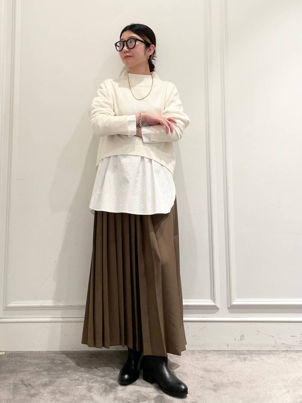 ブラック系のショルダーバッグ、ブラウン系のスカート、ホワイト系のシャツ/ブラウスを着用したレディースの冬コーディネートの2枚目の写真