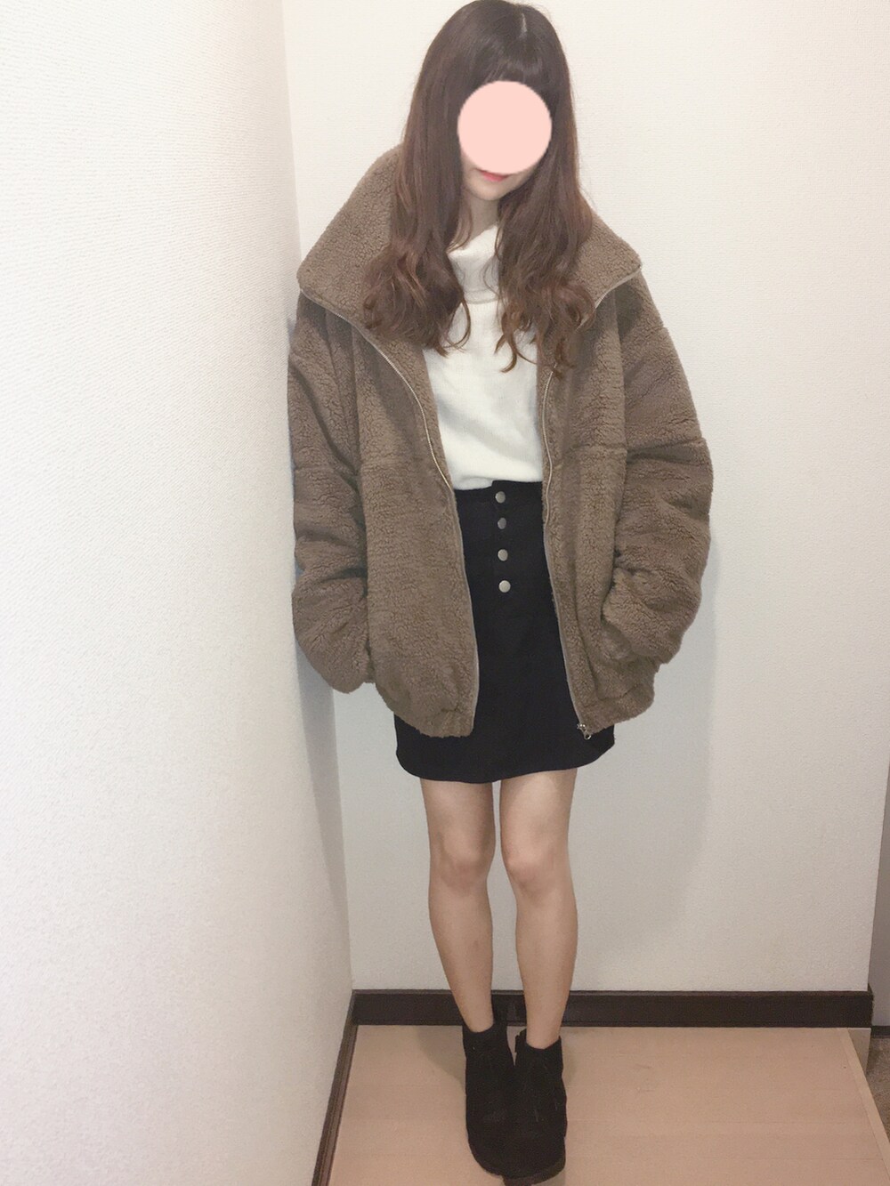 ブラウン系のブルゾン、ブラック系のブーツを着用したレディースの冬コーディネートの2枚目の写真