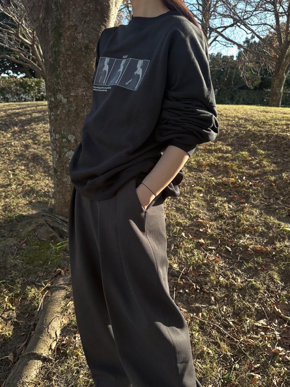 ブラック系のスウェット、グレー系のその他パンツ、ブラック系のスニーカーを着用したレディースの冬コーディネートの2枚目の写真