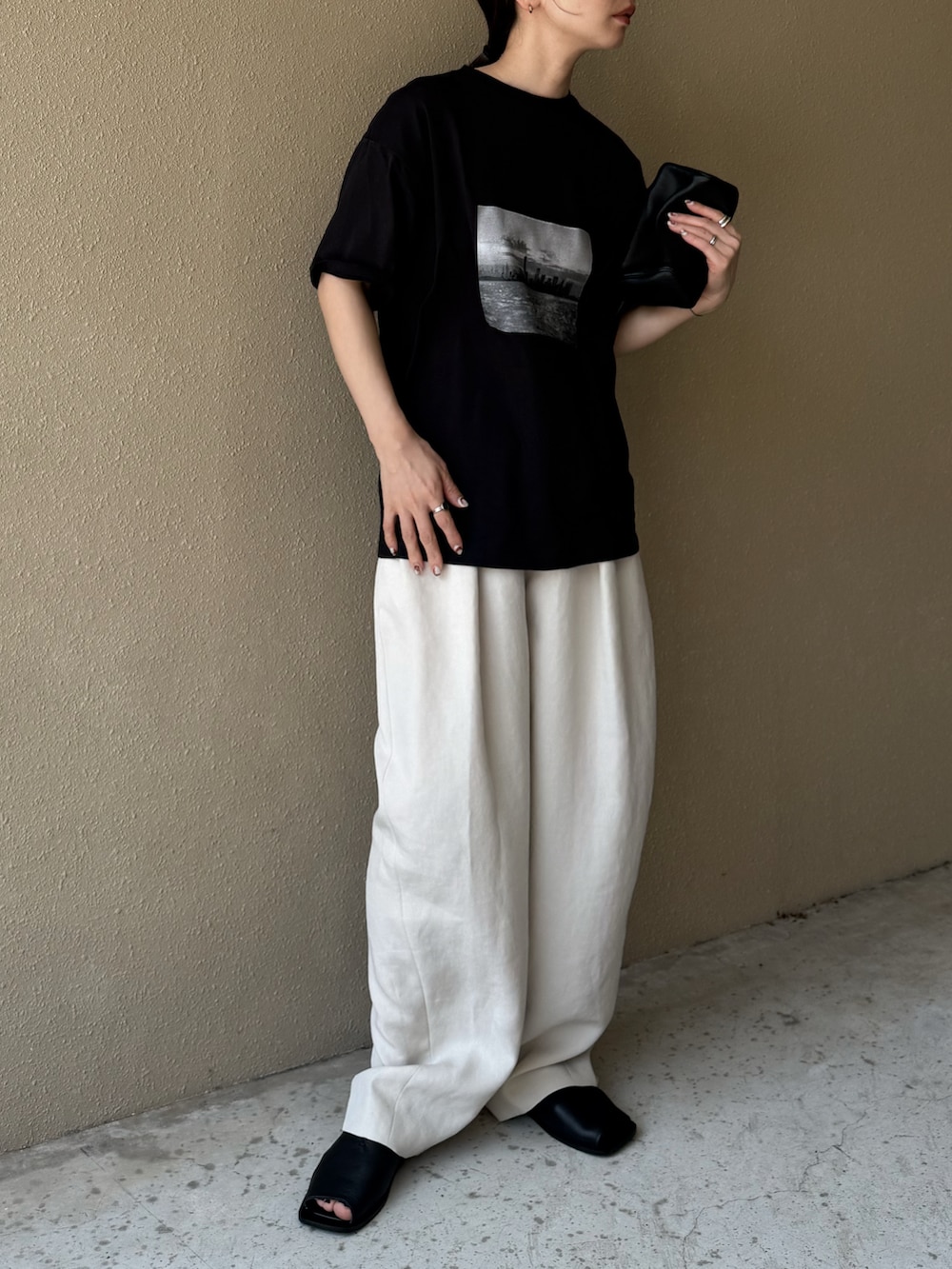 ブラック系のTシャツ/カットソー、ホワイト系のその他パンツ、ブラック系のサンダルを着用したレディースの夏コーディネートの5枚目の写真