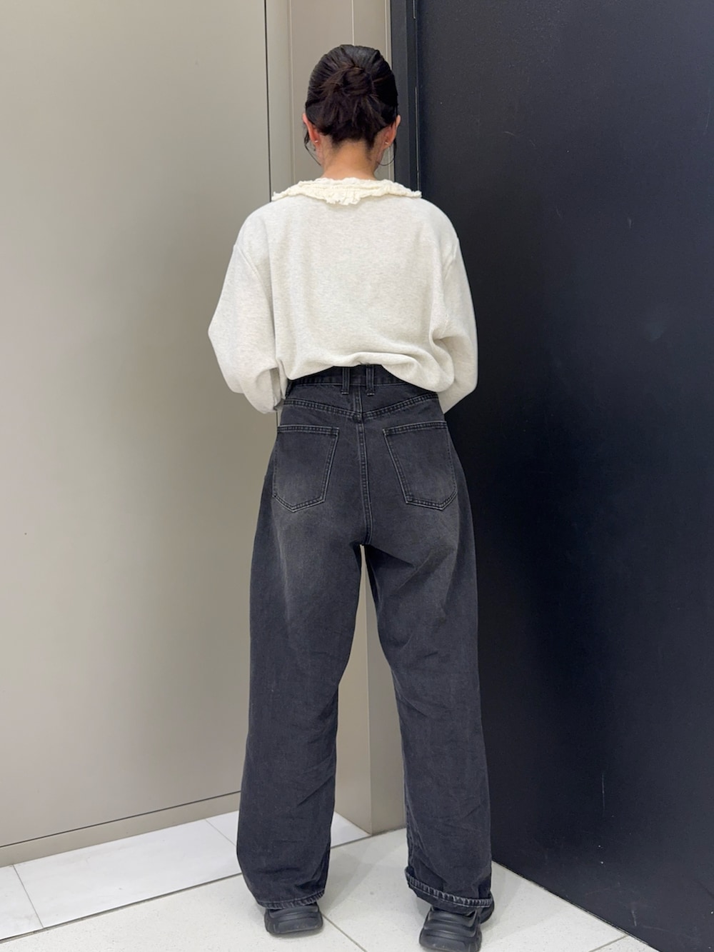 ベージュ系のTシャツ/カットソー、ブラック系のデニムパンツ、ブラック系のスニーカーを着用したレディースの春コーディネートの3枚目の写真