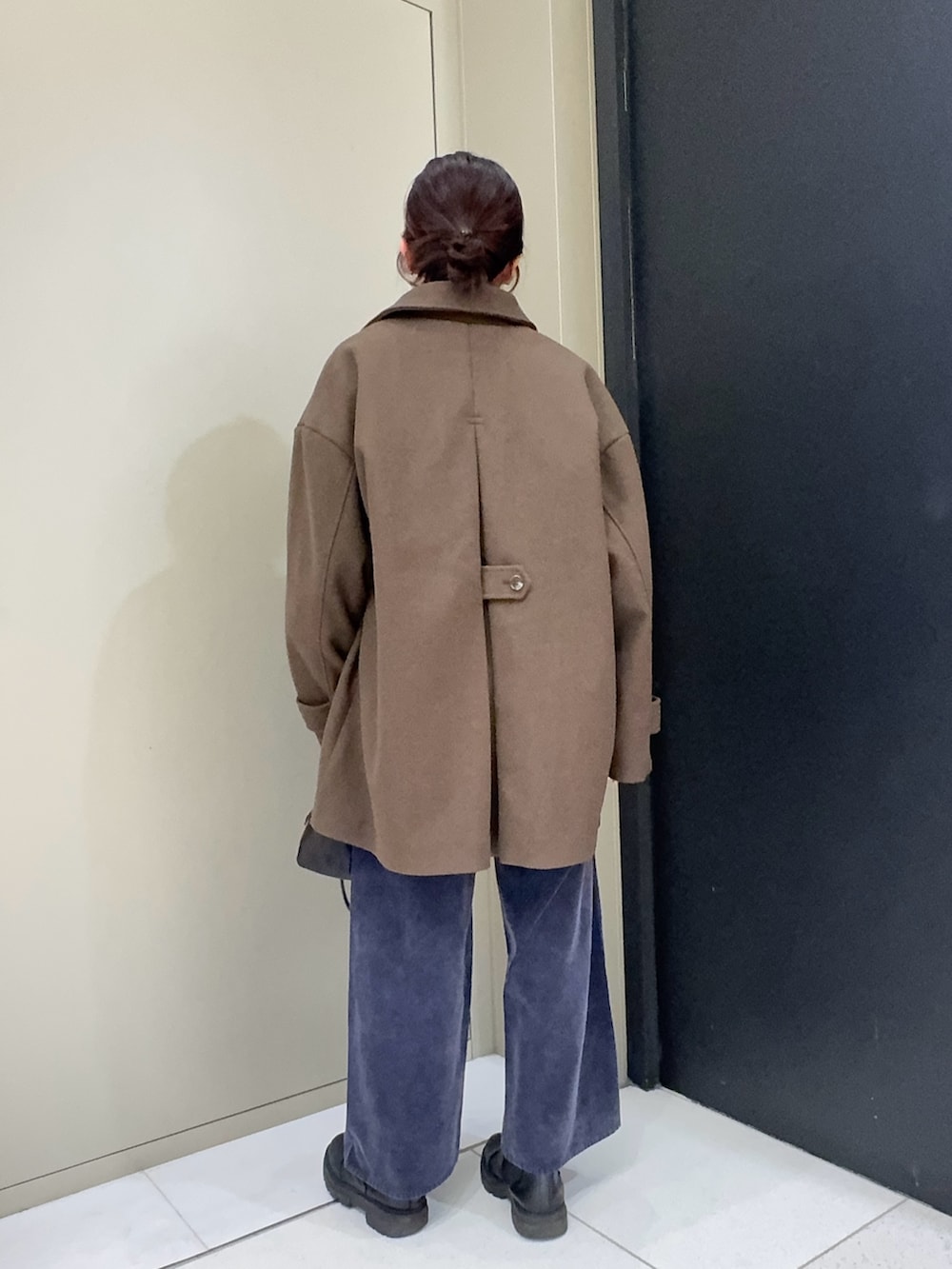 ブラウン系のその他アウター、ブラック系のハンドバッグ、ブルー系のその他パンツを着用したレディースの冬コーディネートの3枚目の写真