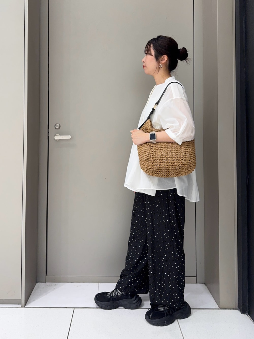 ホワイト系のシャツ/ブラウス、イエロー系のトートバッグ、ブラック系のスニーカーを着用したレディースの夏コーディネートの3枚目の写真