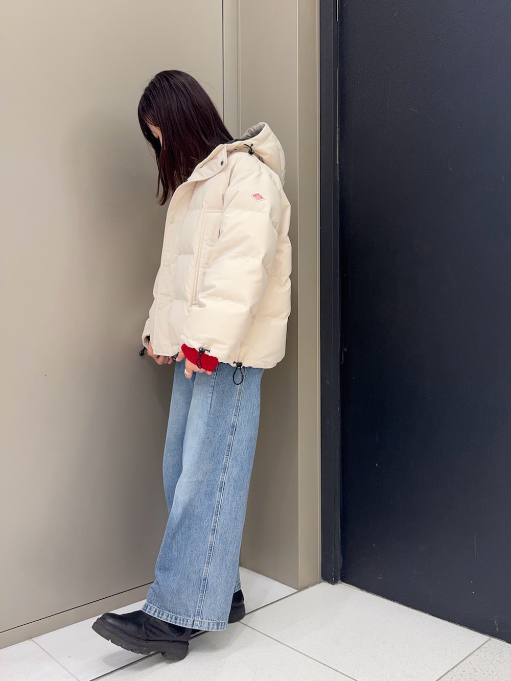 ホワイト系のダウンジャケット/コート、ブルー系のデニムパンツを着用したレディースの冬コーディネートの3枚目の写真