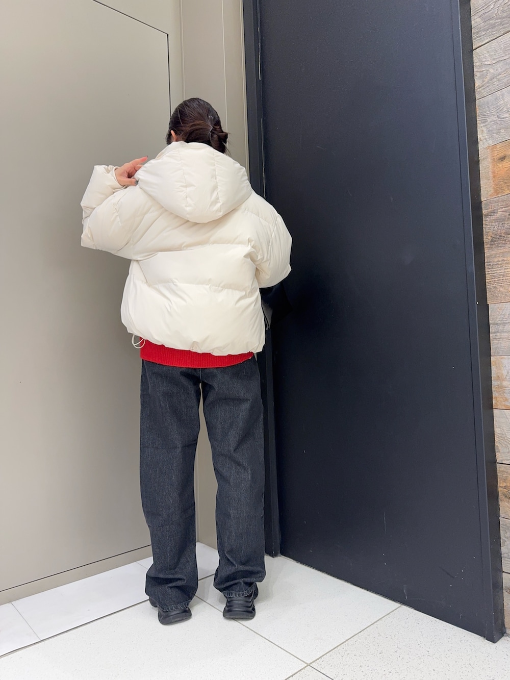 ホワイト系のダウンジャケット/コート、ブラック系のデニムパンツ、ブラウン系のローファーを着用したレディースの冬コーディネートの3枚目の写真