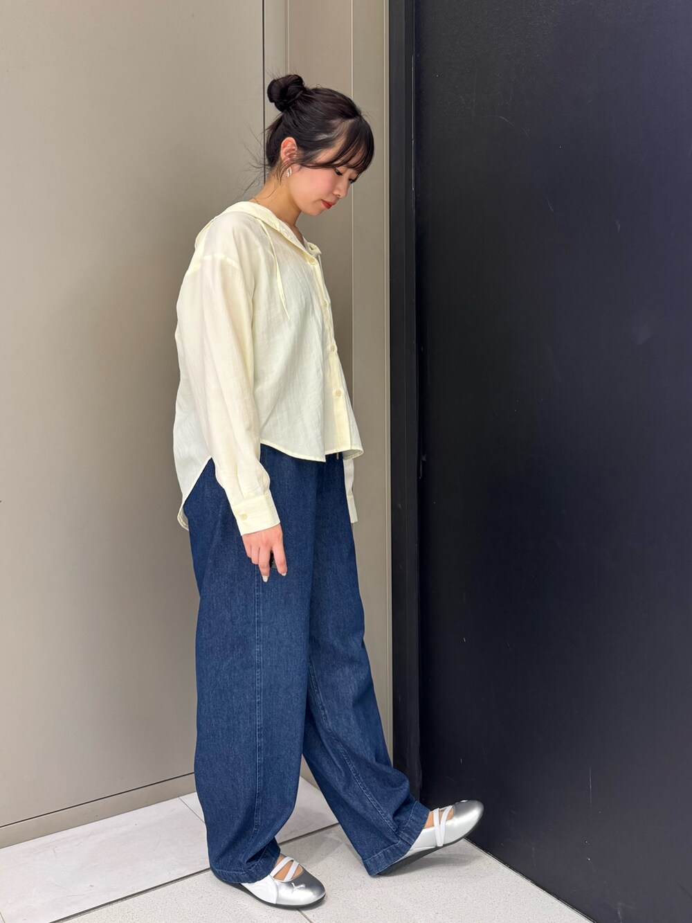 ホワイト系のシャツ/ブラウス、ブルー系のデニムパンツ、シルバー系のスニーカーを着用したレディースの春コーディネートの2枚目の写真