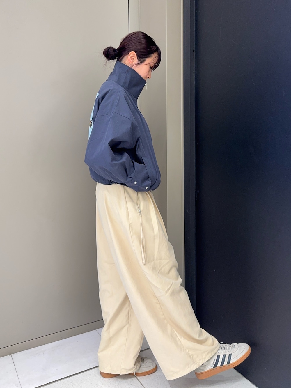 ホワイト系のスニーカー、ベージュ系のその他パンツ、ブルー系のブルゾンを着用したレディースの秋コーディネートの3枚目の写真