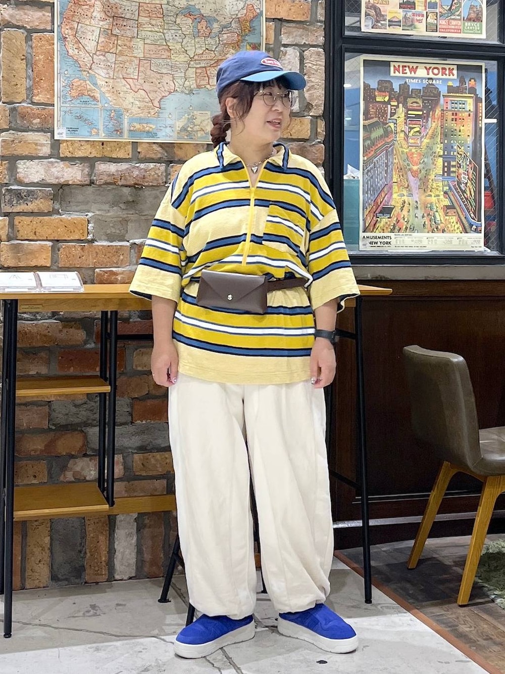 ベージュ系のデニムパンツ、イエロー系のTシャツ/カットソー、ブルー系のキャップを着用したレディースの夏コーディネートの5枚目の写真