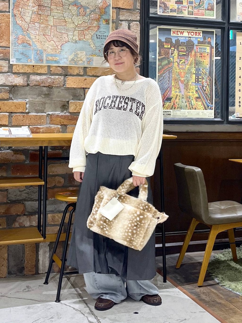 ブラウン系のローファー、ブルー系のデニムパンツ、ベージュ系のニット/セーターを着用したレディースの秋コーディネートの3枚目の写真
