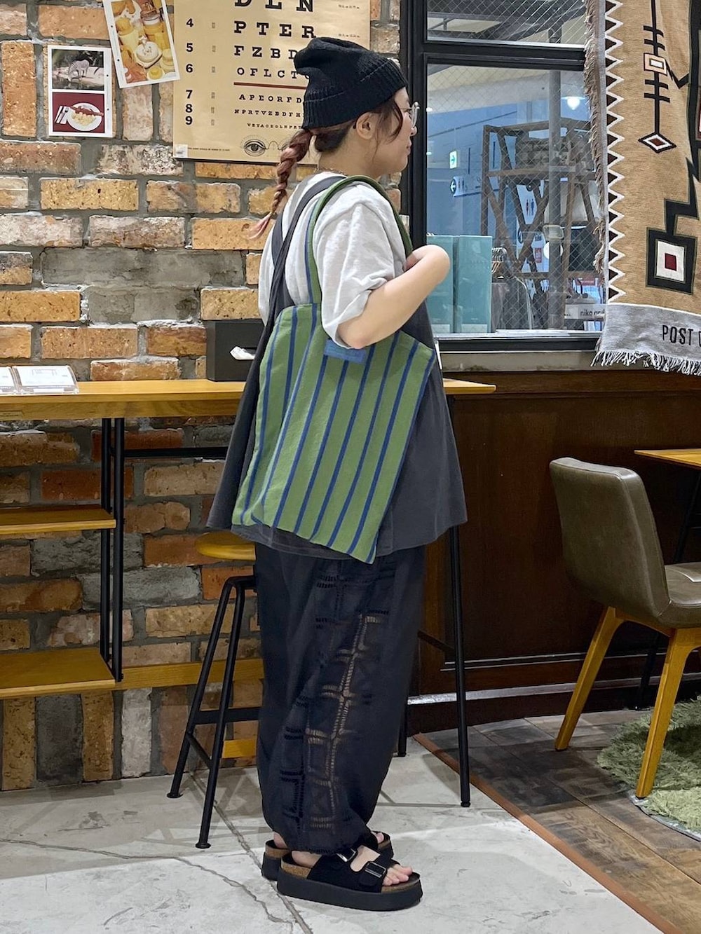 ブラック系のベスト、ブラック系のその他パンツ、ブラック系のサンダルを着用したレディースの夏コーディネートの6枚目の写真