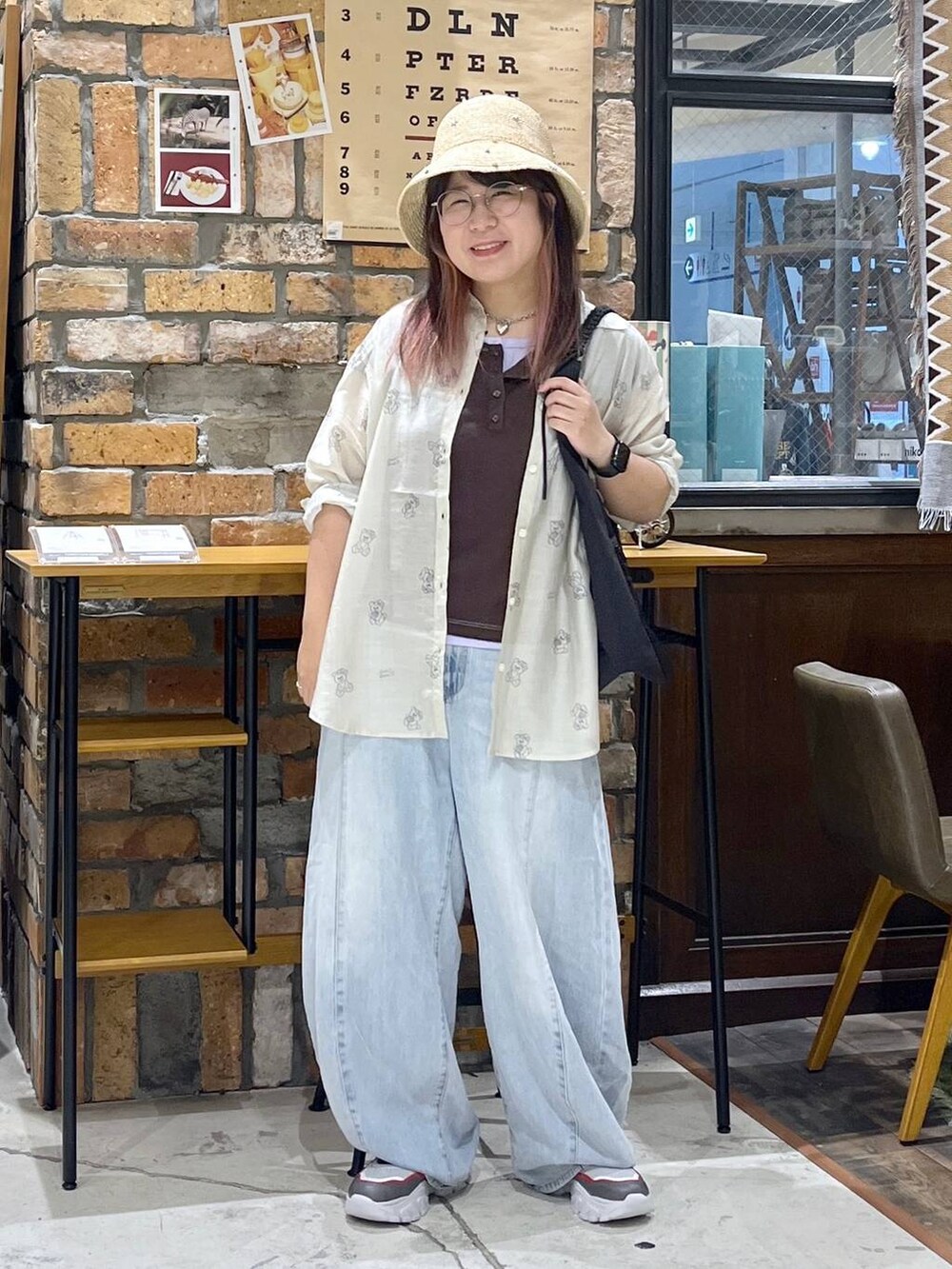 ブルー系のデニムパンツ、その他のスニーカー、ブラック系のトートバッグを着用したレディースの夏コーディネートの3枚目の写真