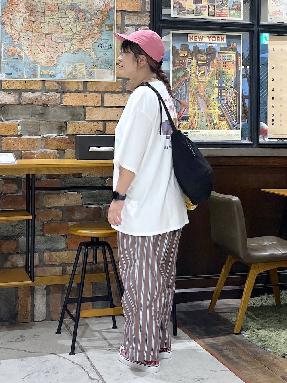 ブラック系のショルダーバッグ、ブラウン系のその他パンツ、ホワイト系のTシャツ/カットソーを着用したレディースの夏コーディネートの3枚目の写真