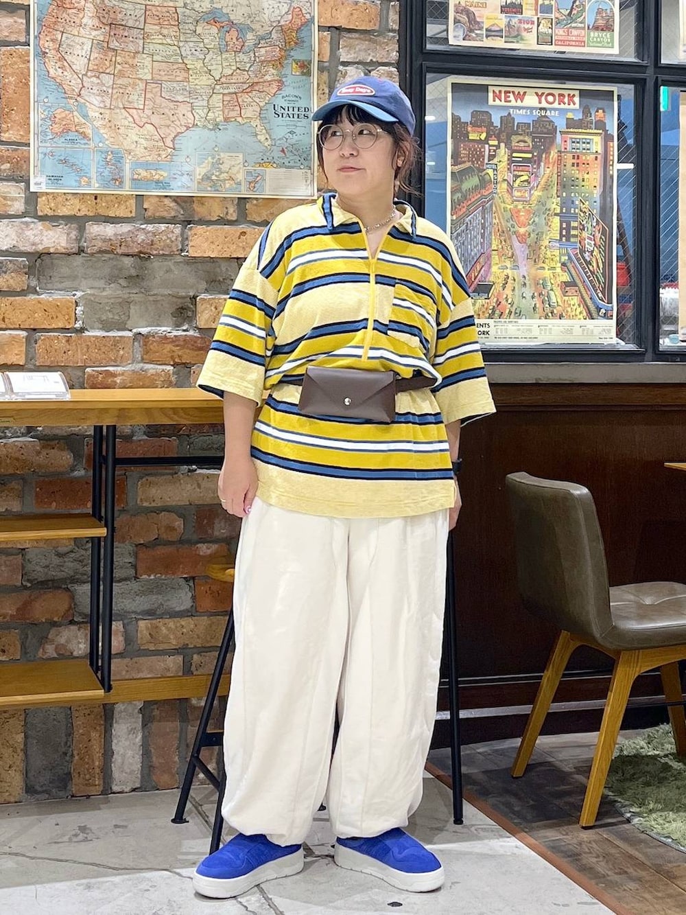 ベージュ系のデニムパンツ、イエロー系のTシャツ/カットソー、ブルー系のキャップを着用したレディースの夏コーディネートの6枚目の写真