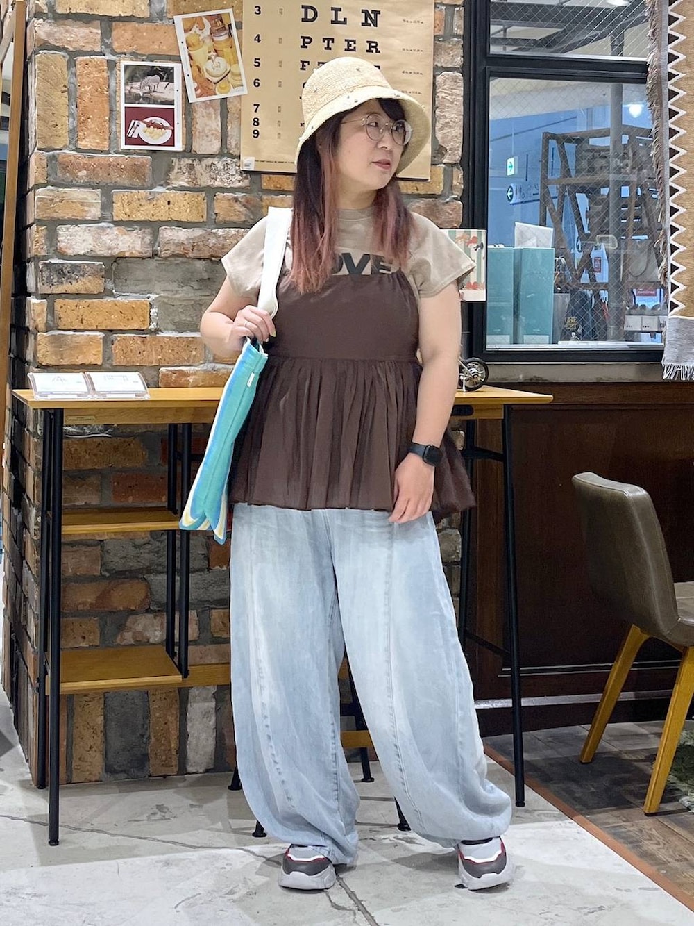 ブルー系のデニムパンツ、その他のスニーカー、レッド系のトートバッグを着用したレディースの夏コーディネートの7枚目の写真
