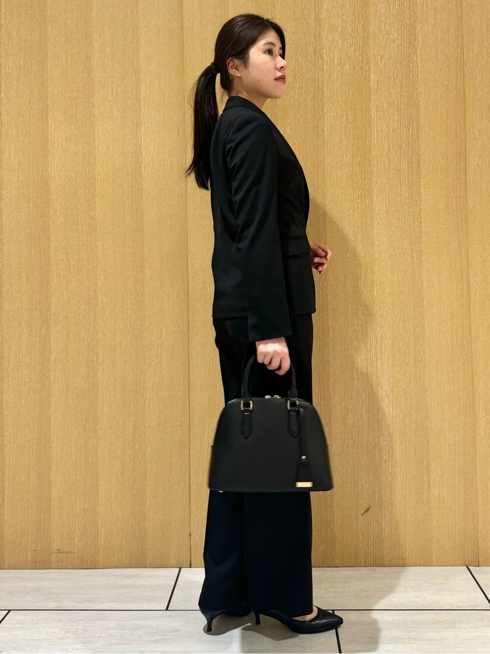 ブラック系のテーラードジャケット、ブラック系のその他パンツ、ブラック系のパンプスを着用したレディースの秋コーディネートの3枚目の写真