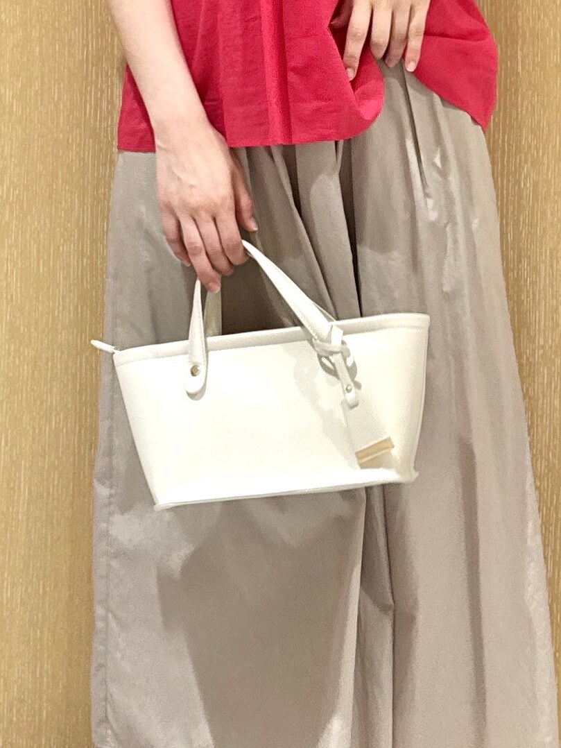 ホワイト系のトートバッグ、ベージュ系のスカート、ピンク系のシャツ/ブラウスを着用したレディースの春コーディネートの9枚目の写真
