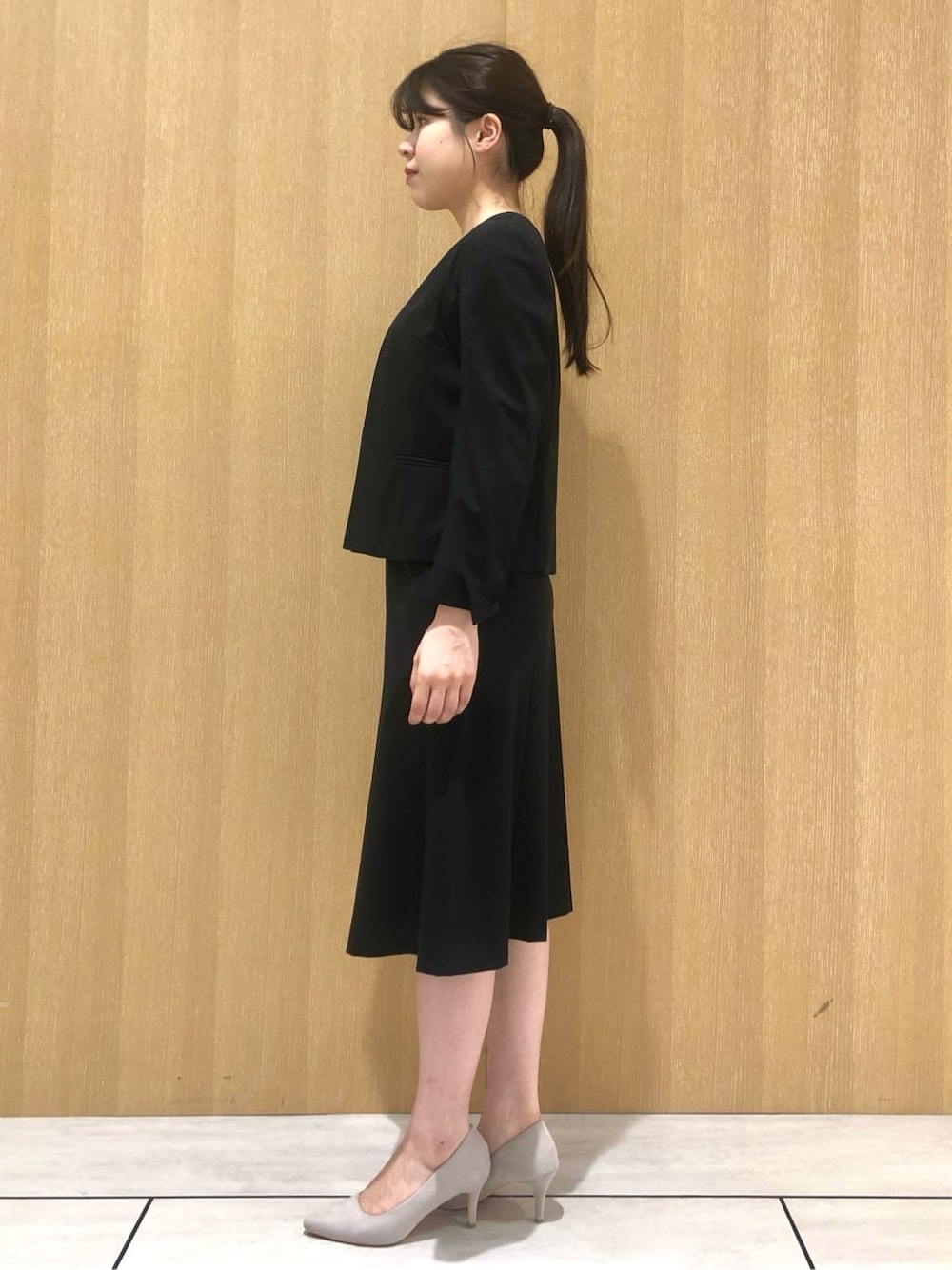 ブラック系のノーカラージャケット、ブルー系のシャツ/ブラウス、ブラック系のスカートを着用したレディースの夏コーディネートの3枚目の写真