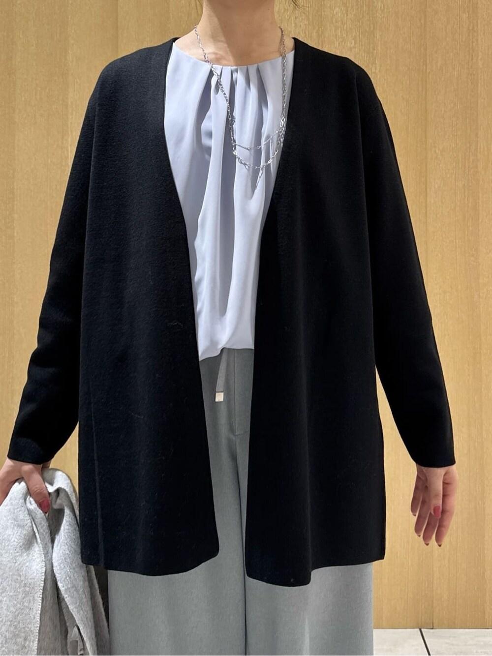 ブラック系のカーディガン/ボレロ、ブルー系のシャツ/ブラウス、グレー系のその他パンツを着用したレディースの冬コーディネートの5枚目の写真