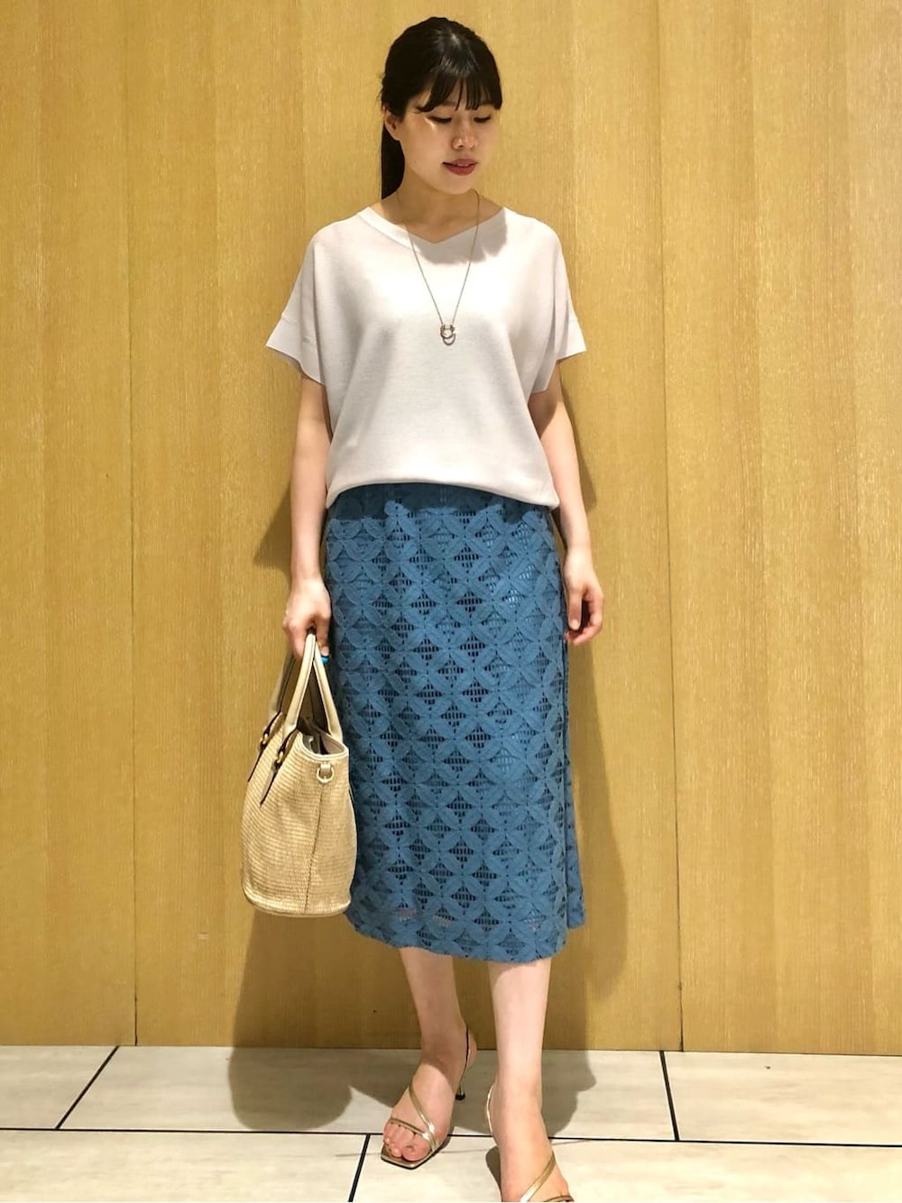 グレー系のニット/セーター、ブルー系のスカートを着用したレディースの夏コーディネートの5枚目の写真