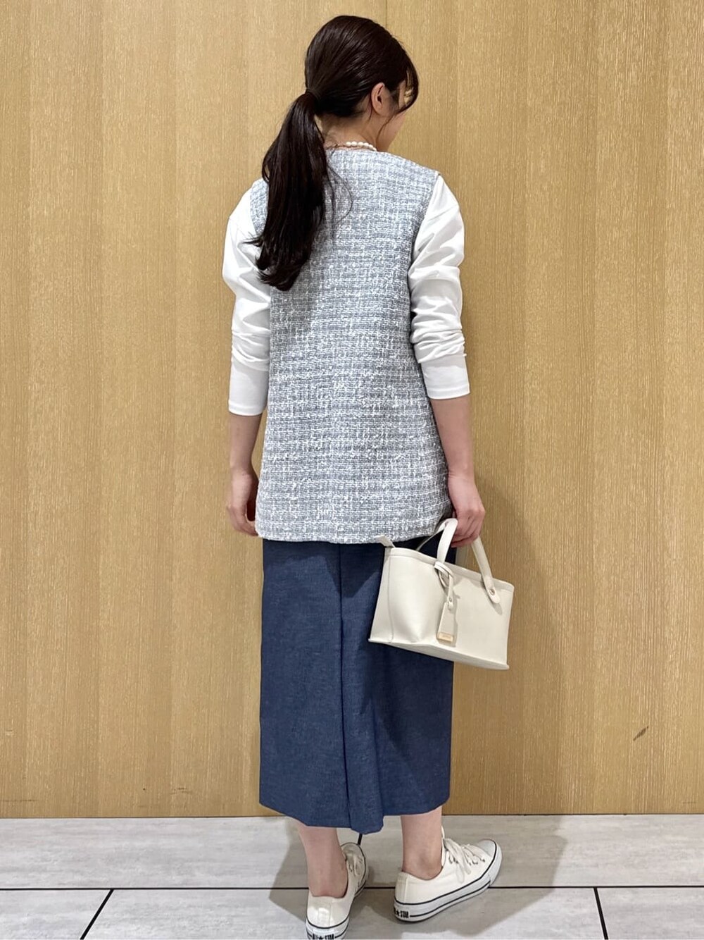 グレー系のブルゾン、ホワイト系のTシャツ/カットソー、ブルー系のスカートを着用したレディースの春コーディネートの3枚目の写真