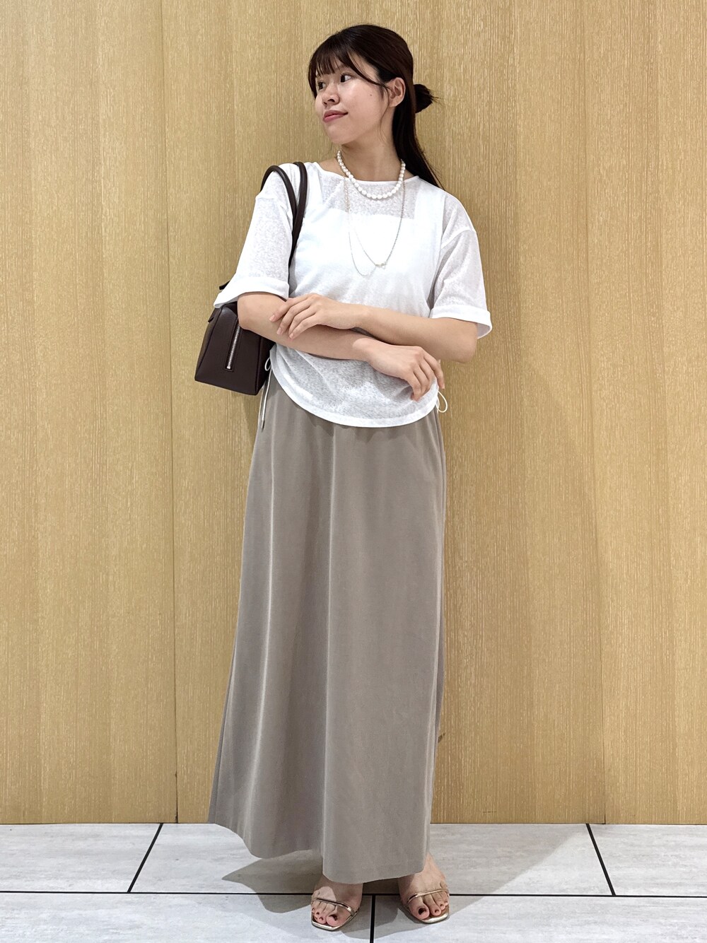 ホワイト系のTシャツ/カットソー、ホワイト系のタンクトップ、グリーン系のスカートを着用したレディースの夏コーディネートの8枚目の写真