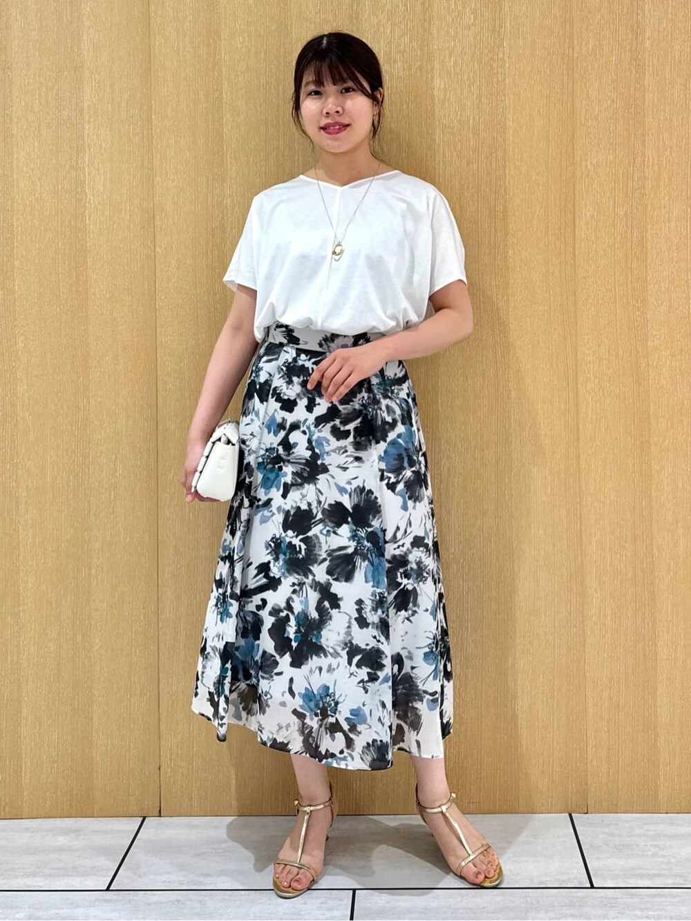 ホワイト系のTシャツ/カットソー、ブルー系のスカートを着用したレディースの秋コーディネートの9枚目の写真