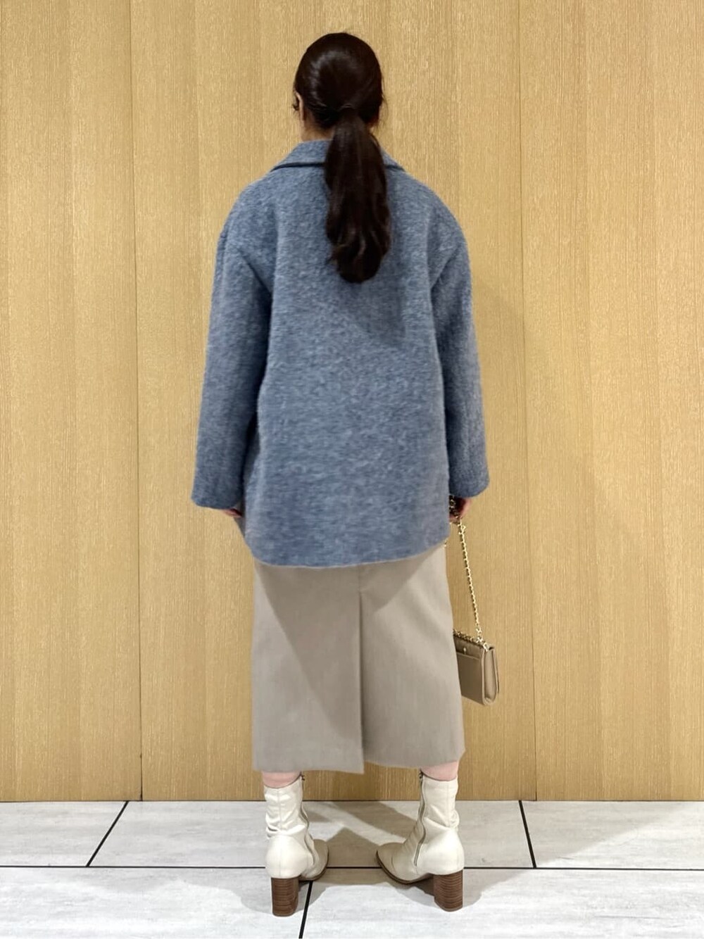 ブルー系のピーコート、ホワイト系のシャツ/ブラウス、ブラウン系のニット/セーターを着用したレディースの冬コーディネートの3枚目の写真