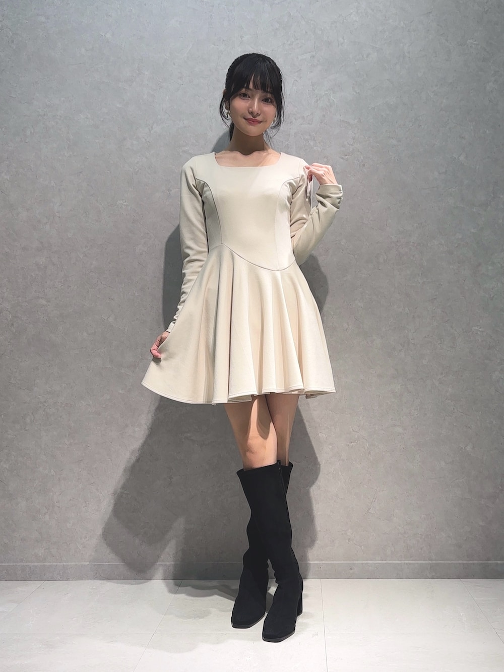 ホワイト系のワンピース、ブラック系のブーツを着用したレディースの秋コーディネートの3枚目の写真