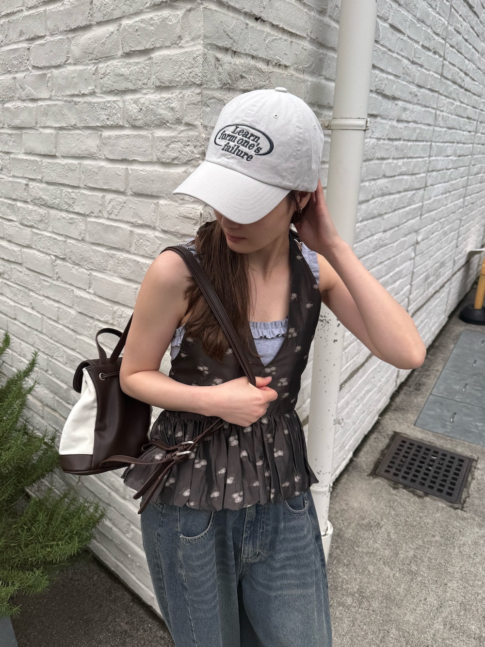ブラック系のシャツ/ブラウス、ホワイト系のキャップを着用したレディースの春コーディネートの3枚目の写真